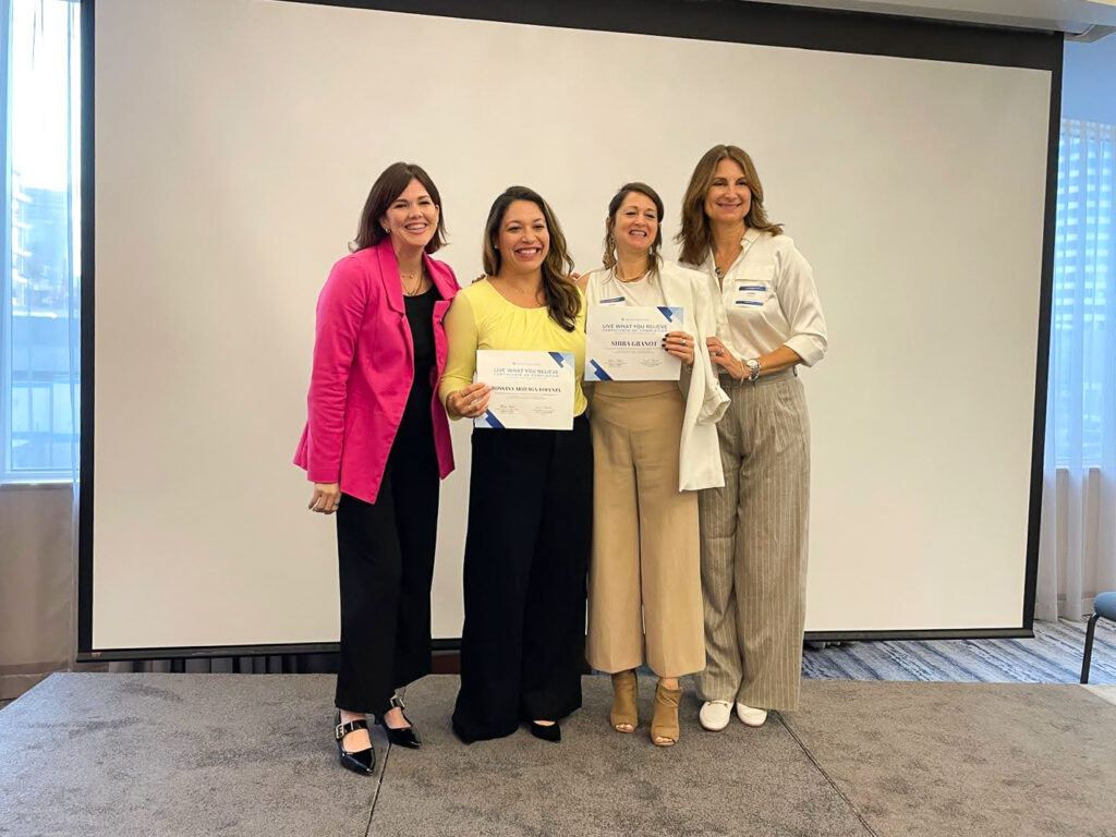 Four women pose for a photo, two are presented with their award certificates by Kasey Brennan (left) and Shirin Taber (right).